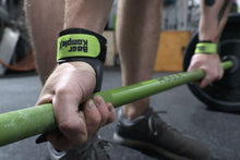 Load image into Gallery viewer, Man gripping a barbell wearing Bear Komplex Diamond 3-Hole Gymnastic Grips with Green Velcro Strap | FreeAthlete