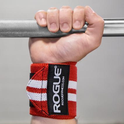 Man gripping bar to showcase Rogue Wrist Wraps - White Series in Red with White Stripes