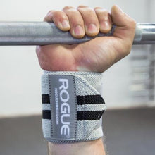 Load image into Gallery viewer, Man gripping bar to showcase Rogue Wrist Wraps - White Series in Grey with Black Stripes